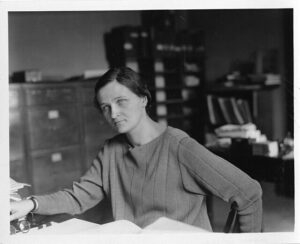 Image of Cecilia Payne Gaposchkin seated at her desk. 