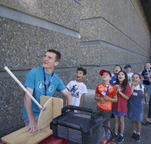 Aerospace Summer Campers launch paper rockets at Evergreen Aviation & Space Museum.